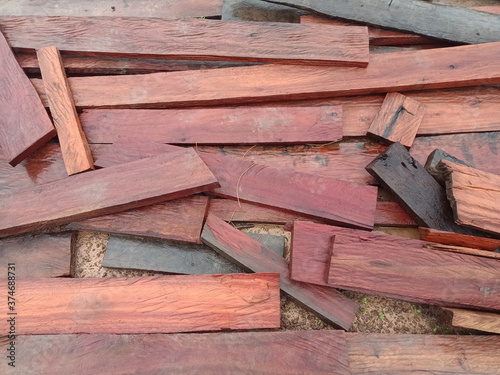 the stack of  wet sheets hard wood  on ground in rainy day