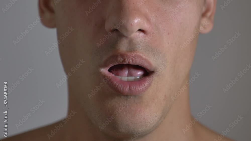 Man coughing in his fist.close-up portrait of a sick man who suffers from cough. Man coughing in his fist.close-up portrait of a sick man who suffers from cough.
