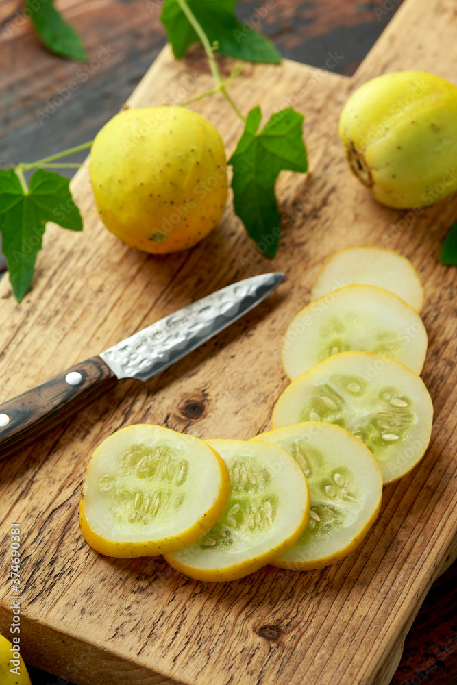 Lemon Cucumbers slices on wooden board. healthy food.
