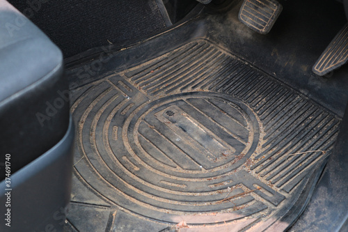 Dirty car floor mats of black rubber.