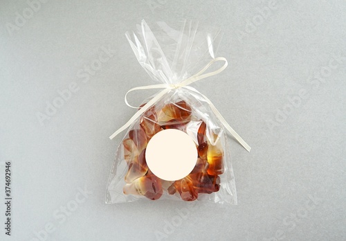 Obraz na plátně Party favor bag and empty round sticker mockup, blank sticker for design, silver background, birthday, baby shower, wedding favor bag label mockup