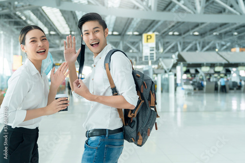 Photography two attractive asian businessman and businesswoman hand gesture wave greeting an