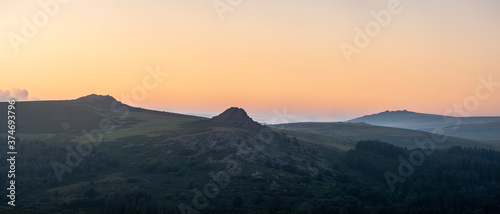 Absolutely stunning landscape image of Dartmoor in England showing Leather Tor, Sharpitor and Kings Tor in majestic sunrise light