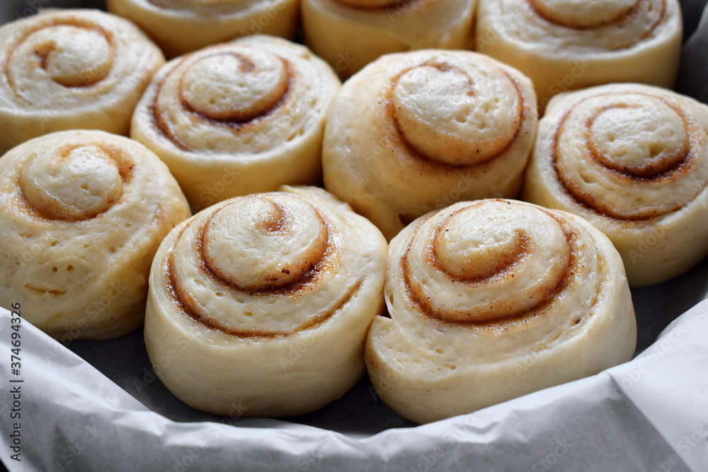 Raw cinnamon rolls of yeast dough ready to be baked