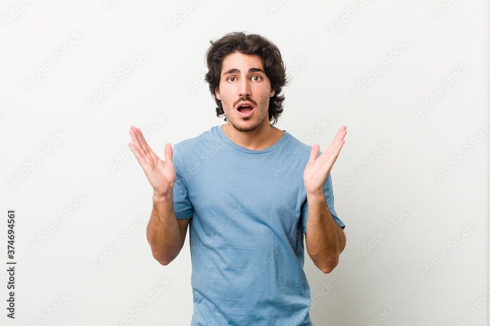 Young handsome man against a white background surprised and shocked. Young handsome man against a white background surprised and shocked.