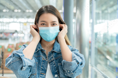 close up portrait attractive female hand wear takeoff face mak protection safety travel concept new normal lifestyle at departure airport terminal