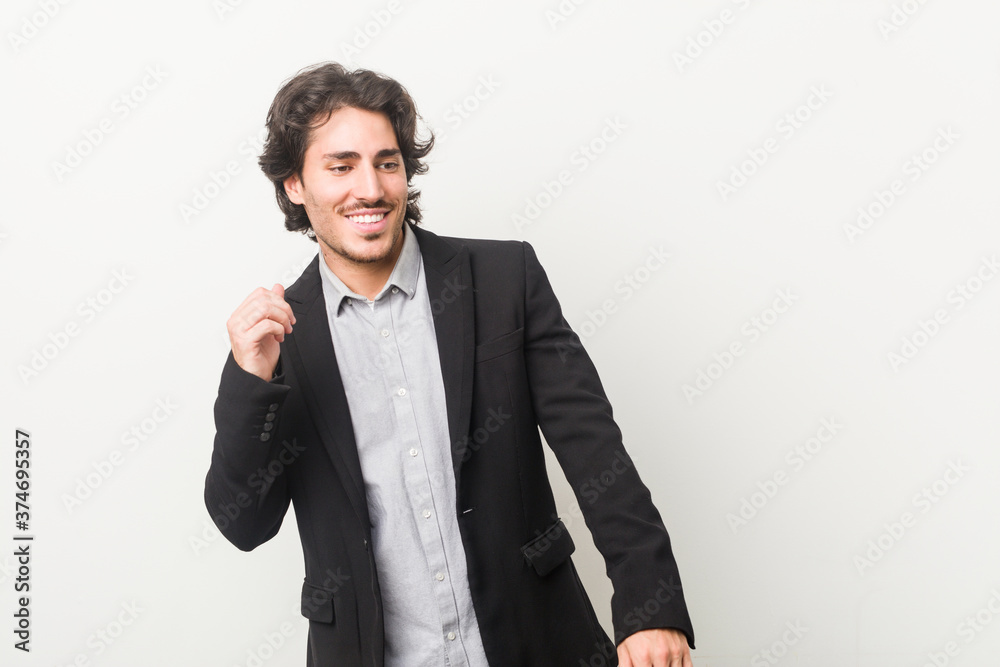Young business man against a white background dancing and having fun. Young business man against a white background dancing and having fun.