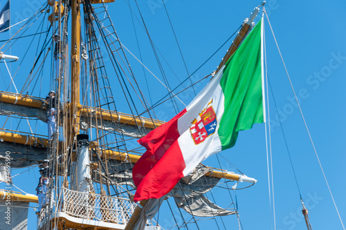 Italian Navy flag waving on the training ship of the Italian Navy "AMERIGO VESPUCCI" in the harbour of Taranto, Italy