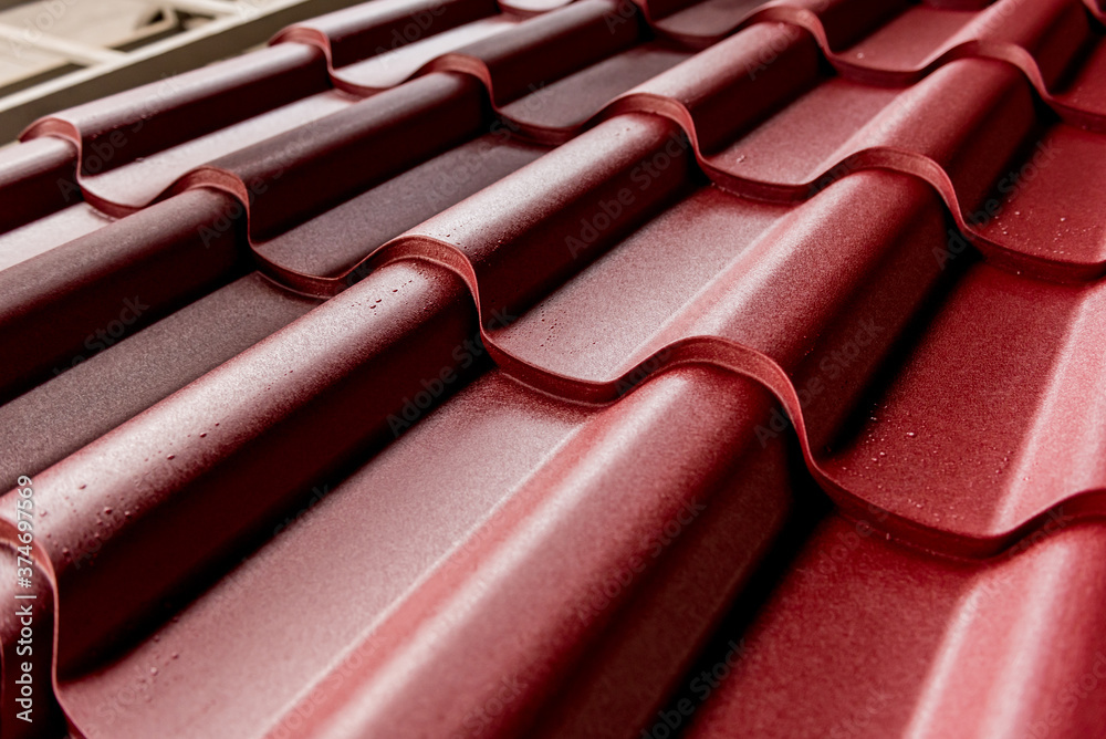 Red metallic roof tiles background with drops of water. Red metallic roof tiles background with drops of water.