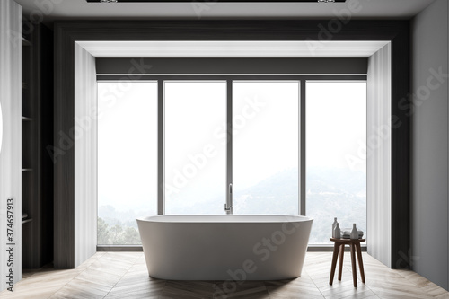 Grey and wooden bathroom interior with tub