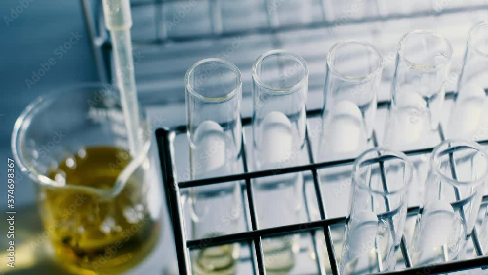 The scientist dropping the chemical solution in test tube in the laboratory experiment. Chemical and Oil concept