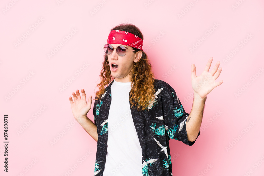 Young hippie caucasian man isolated being shocked due to an imminent danger Young hippie caucasian man isolated being shocked due to an imminent danger