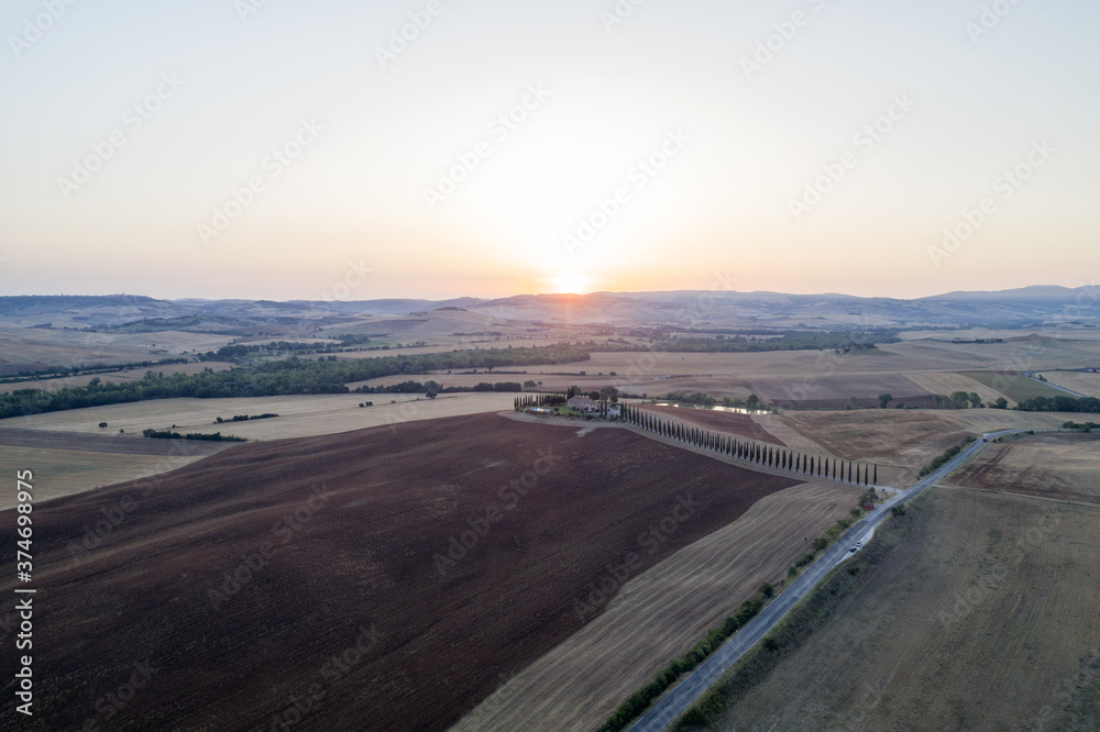 Aerial view of dawn in the valley of the edge, the sun just arose, the countryside in Tuscany Aerial view of dawn in the valley of the edge, the sun just arose, the countryside in Tuscany