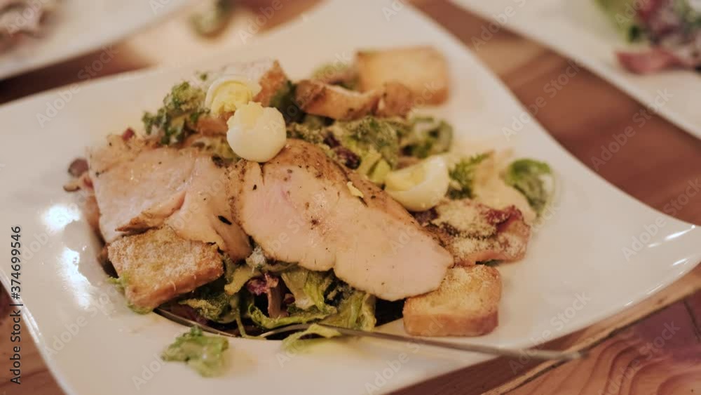 The cook adds quail eggs to Caesar salad. The chef makes a presentation of dishes. The cook adds quail eggs to Caesar salad. The chef makes a presentation of dishes.