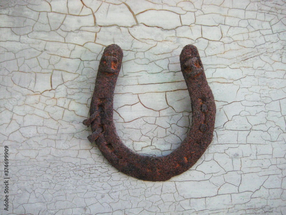 old rusty horseshoe on wooden background
