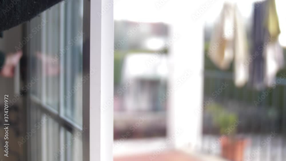 young man closing balcony sliding window door 4k