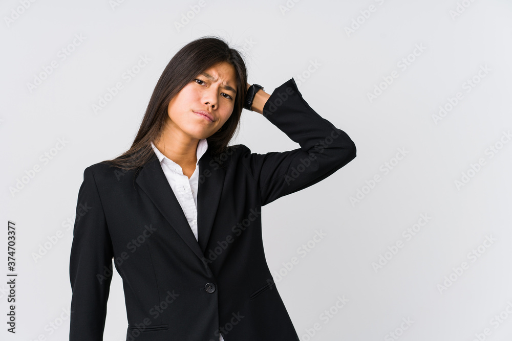 Young asian business woman touching back of head, thinking and making a choice. Young asian business woman touching back of head, thinking and making a choice.