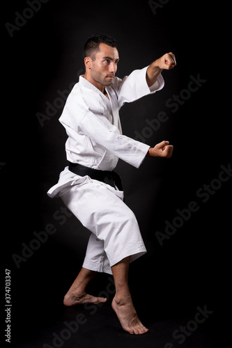 karateka practicing kata with black background