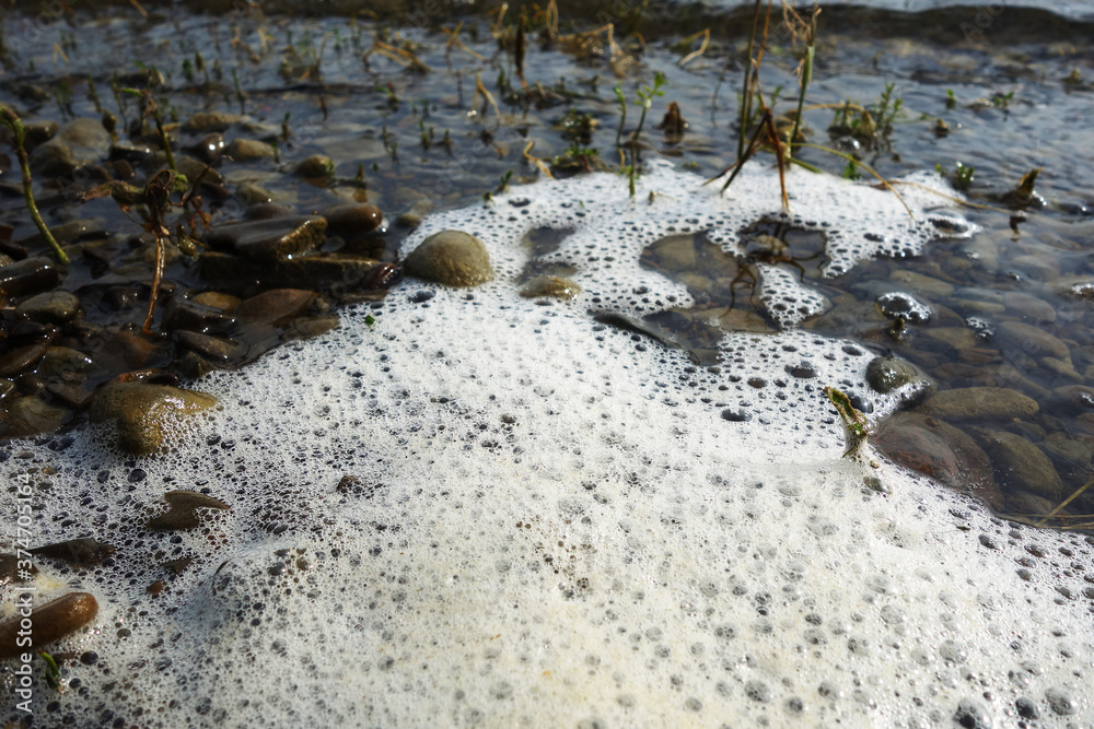 Stack of foam on the shore of Lake accumulated torrential waves Stack of foam on the shore of Lake accumulated torrential waves