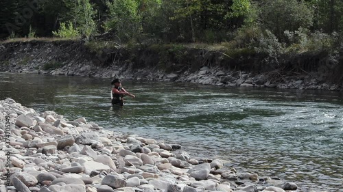 senior woman enjoying fly fishing in SloMo 