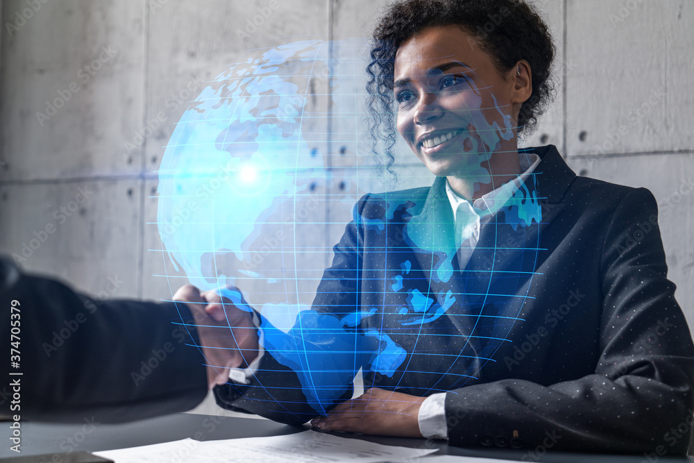 Two woman handshake. World map planet earth hologram. Multiexposure. International business. Two woman handshake. World map planet earth hologram. Multiexposure. International business.