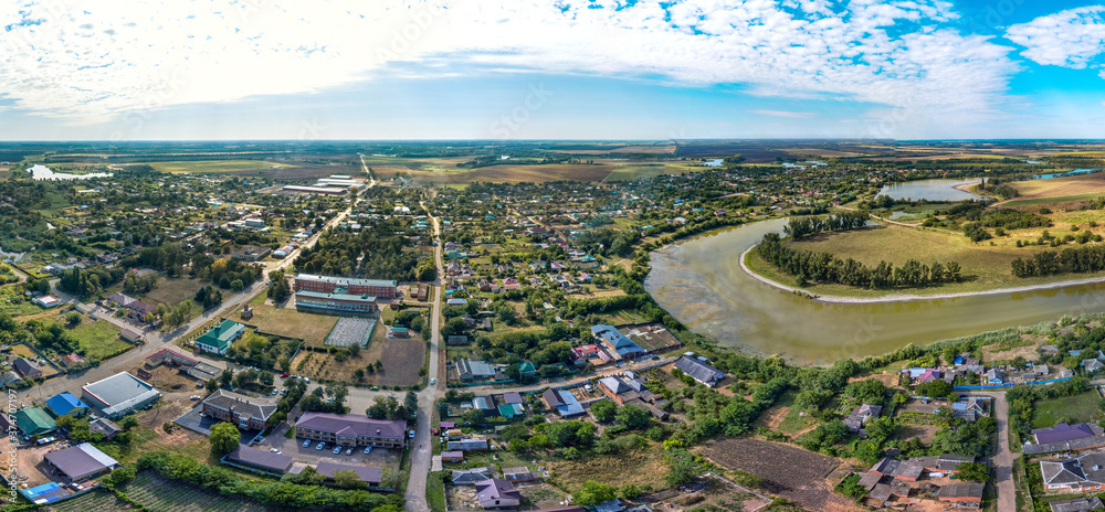 aerial panorama of the village of Sergievskaya (South of Russia) and the bend of the Kirpili river on a sunny summer day