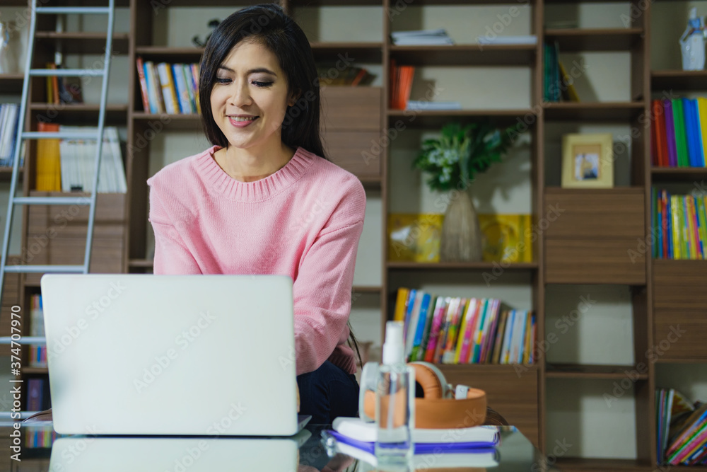 Young beautiful happy women using laptop working from home Young beautiful happy women using laptop working from home