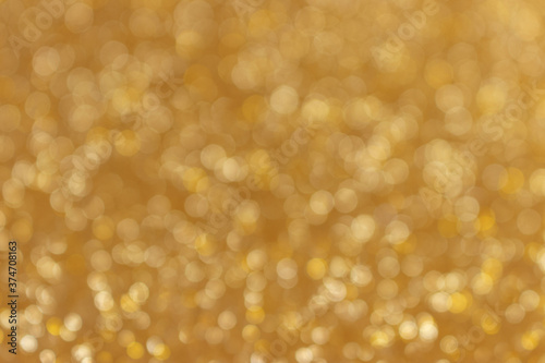 Golden glitter texture background. Shiny defocused backdrop.