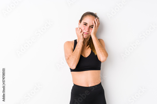 Young caucasian fitness woman posing in a white background whining and crying disconsolately. © Asier