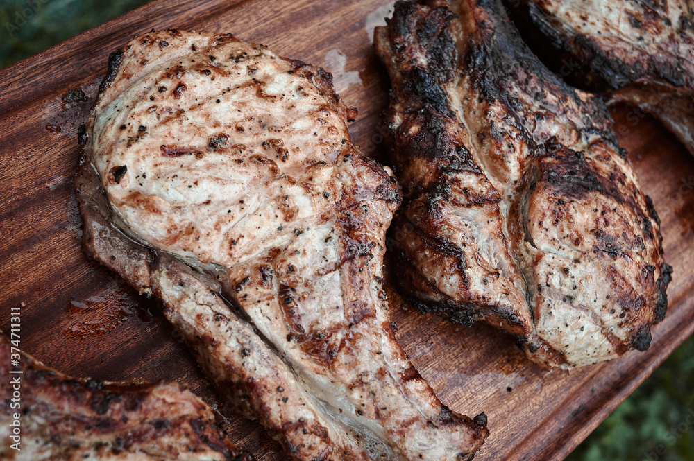 pieces of fried steak on a mahogany board, close-up photo pieces of fried steak on a mahogany board, close-up photo