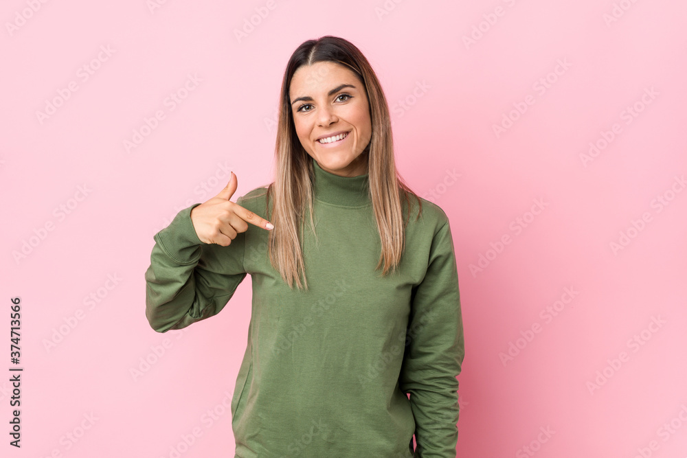 Young caucasian woman isolated person pointing by hand to a shirt copy space, proud and confident Young caucasian woman isolated person pointing by hand to a shirt copy space, proud and confident