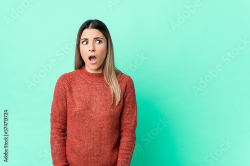 Young caucasian woman isolated being shocked because of something she has seen.