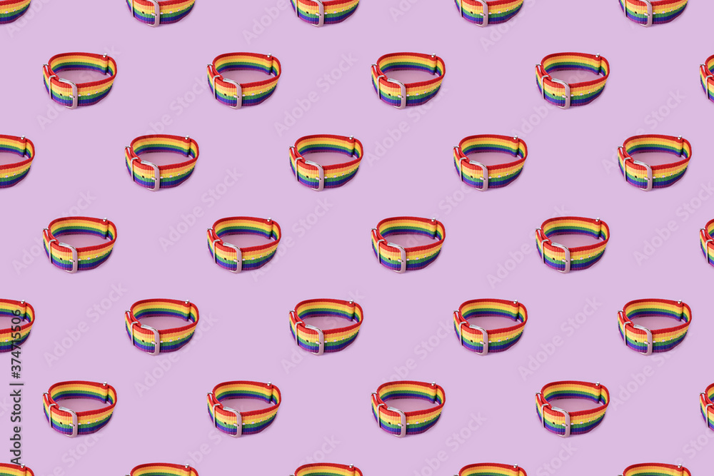 Lgbt bracelet on lilac background, pattern. The concept of sexual tolerance, stop homophobia, same-sex relationships, homosexuality. Long horizontal banner. Lgbt bracelet on lilac background, pattern. The concept of sexual tolerance, stop homophobia, same-sex relationships, homosexuality. Long horizontal banner.