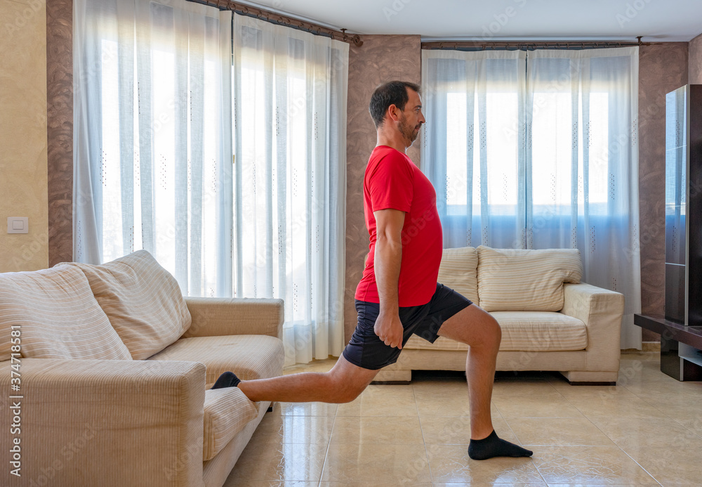 Bearded man in low shape exercising with black and red sportswear Bearded man in low shape exercising with black and red sportswear