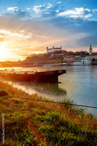 view of Bratislava castle on late afternoon with beautiful sunset on river Danube, Slovakia