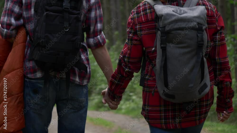 young couple walking in the forest in the mountains young couple walking in the forest in the mountains