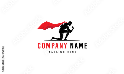 Vector logo on which an abstract image of a superman with a red cloak who kneeled.