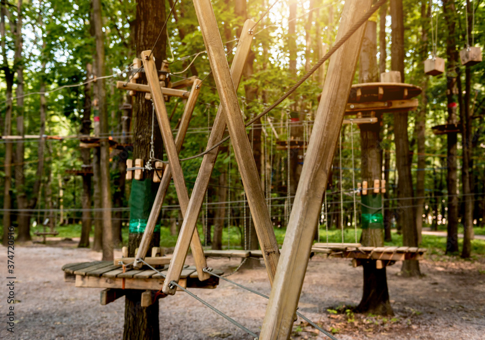 Fototapeta premium Rope park in a forest. Adventure summer park.