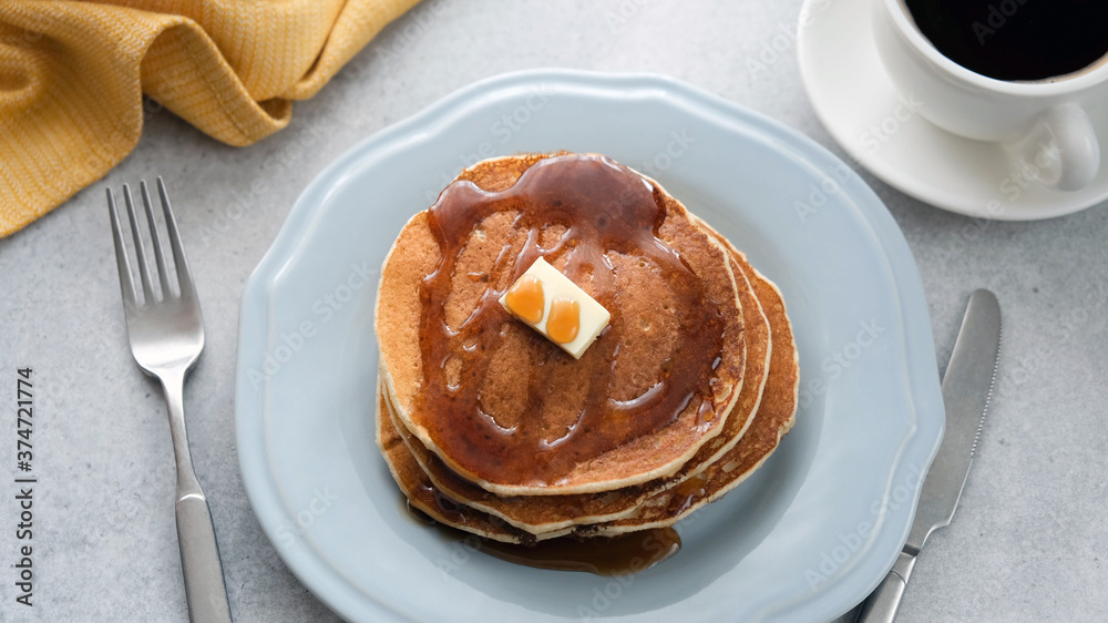 Pancakes with butter and maple syrup on plate, breakfast food Pancakes with butter and maple syrup on plate, breakfast food