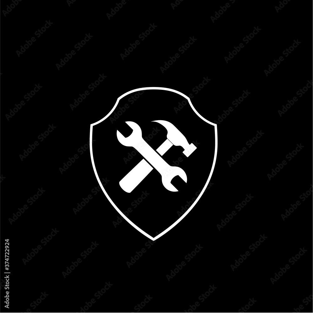 Hammer and wrench with shield icon isolated on dark background Hammer and wrench with shield icon isolated on dark background
