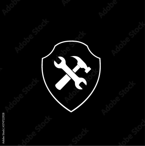 Hammer and wrench with shield icon isolated on dark background