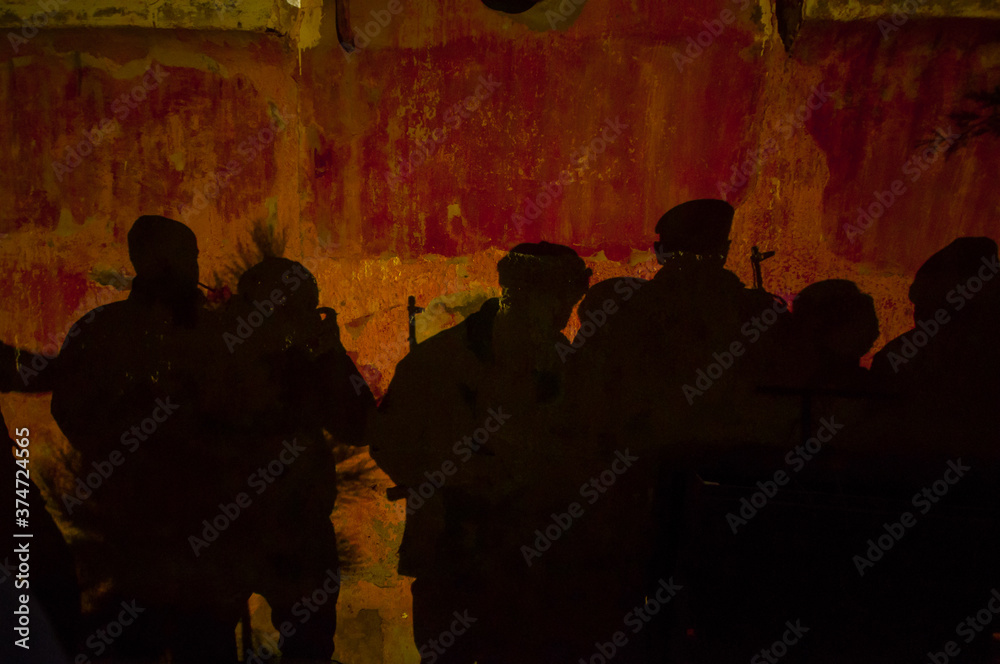 Shadow of soldiers on wall at night. Army concept. Fighting silhouettes on colored stone wall Shadow of soldiers on wall at night. Army concept. Fighting silhouettes on colored stone wall