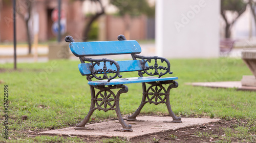 Ancient wooden benches in the village park. Wonderful old iron structure adorable gray tone black metal with ornaments, a perfect seat, city square background image. Selective focus