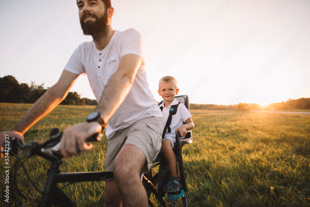 Father and his son cycling together outdoors