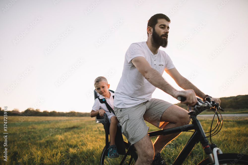 Father and his son cycling together Father and his son cycling together