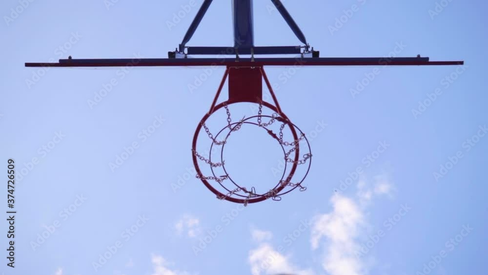 Close-up Basketball Hoop. Orange Ball Flies Into Basketball Hoop, Slow Motion Close-up Basketball Hoop. Orange Ball Flies Into Basketball Hoop, Slow Motion