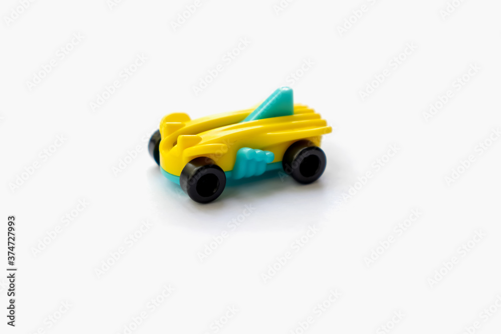 Isolated object of a small plastic racing car for children on a white background space for text Isolated object of a small plastic racing car for children on a white background space for text