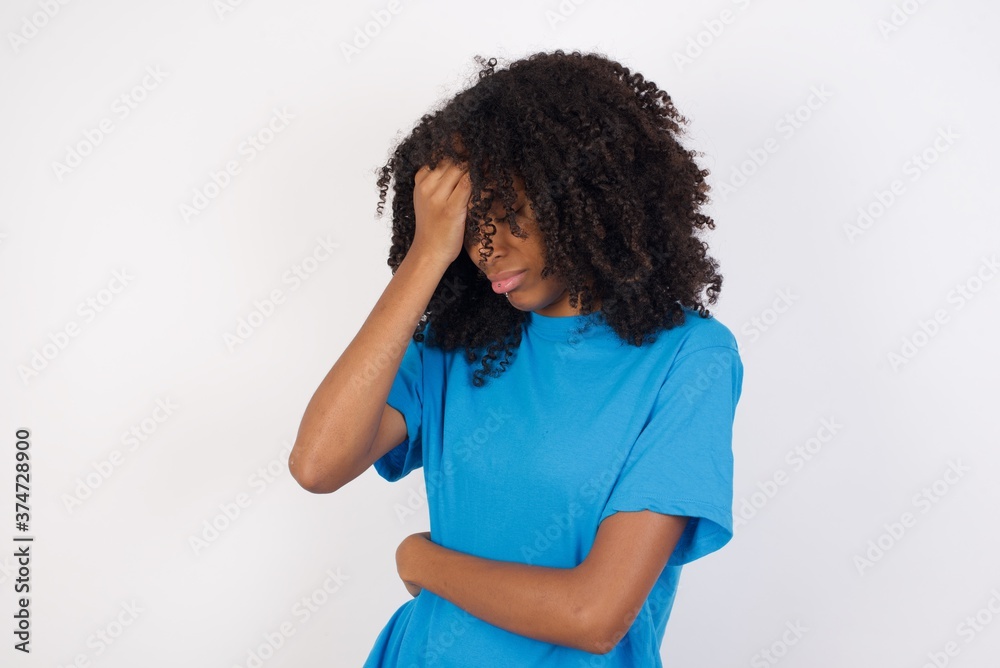 A very upset and lonely Young african woman with curly hair wearing casual blue shirt. crying, A very upset and lonely Young african woman with curly hair wearing casual blue shirt. crying,