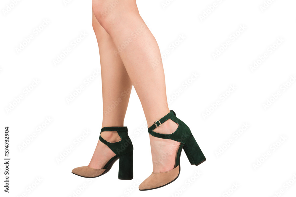 Woman legs in green and beige sandals on heels. Woman legs in green and beige sandals on heels.