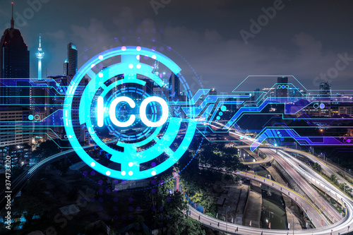 Initial coin offering hologram, night panorama city view of Kuala Lumpur. KL is the center of cryptocurrency projects in Malaysia, Asia. The concept of widespread ICO hysteria. Double exposure.